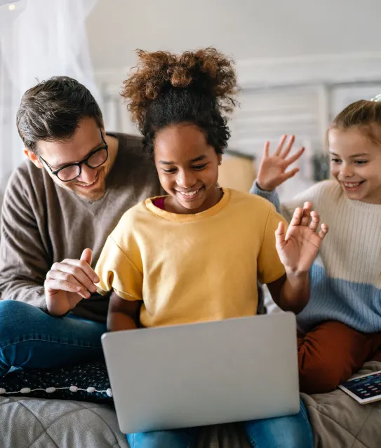 Parent and tow young kids on a video call